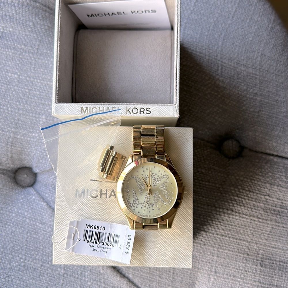 MK gold . New with tag , size adjusted to my wrist extra links included.